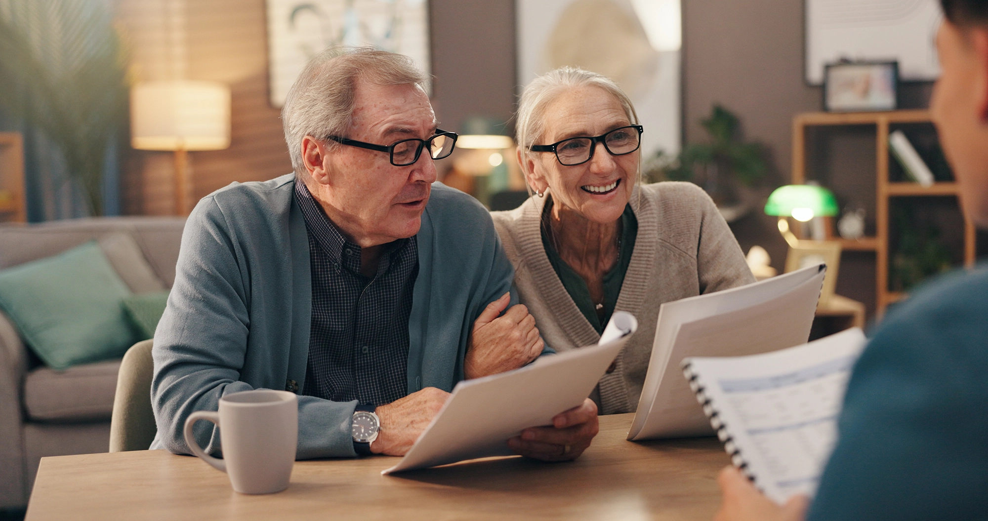 Elderly couple meeting with estate planning attorney to review legal documents and long-term care options