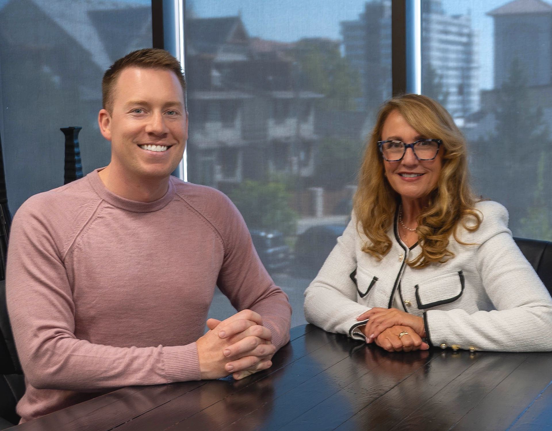 Jeremy Keel and Stacey Janssen sitting together at a conference table, representing compassionate estate and elder law support