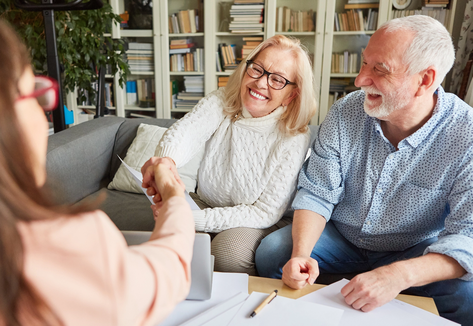 Smiling elderly couple meeting with a probate attorney to discuss estate administration and document review