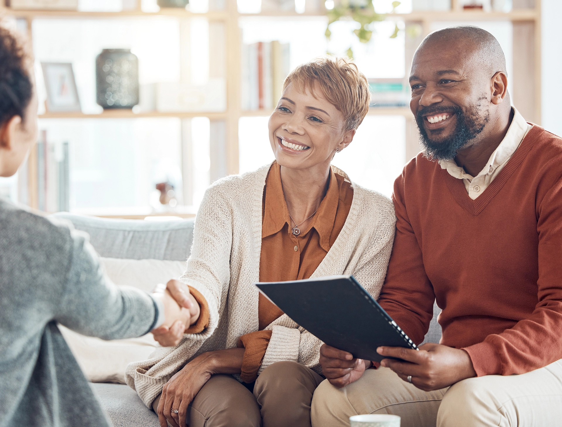 Smiling couple meeting with an estate planning attorney to discuss wills, trusts, and long-term protection